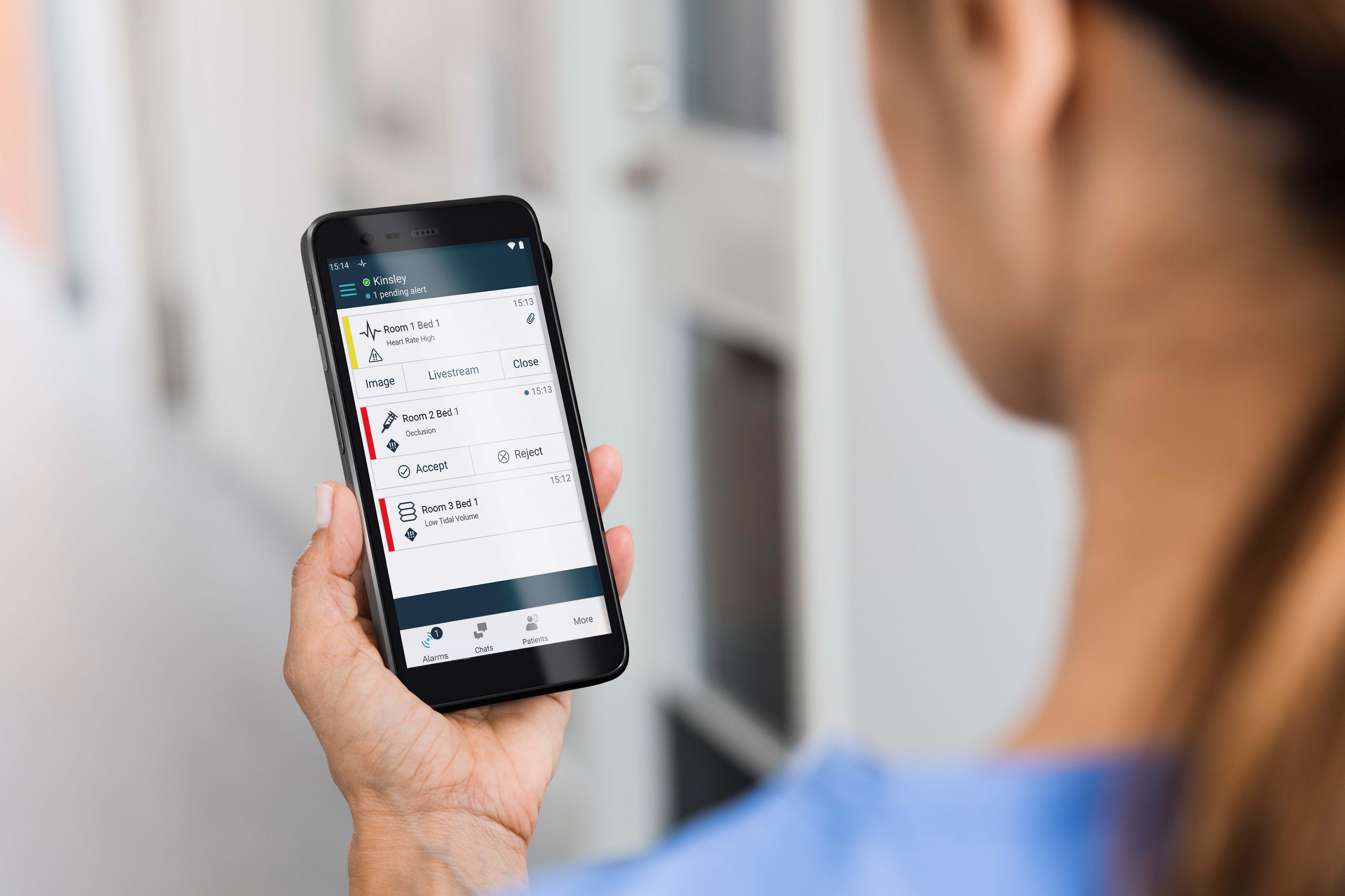 Nurse looking at data on myco4 phone