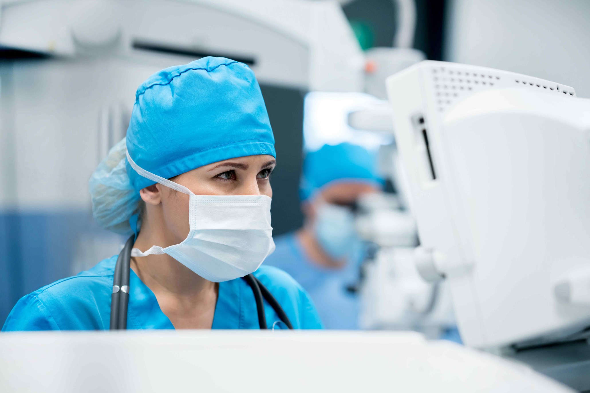 Portrait of an OR nurse observing a medical equipment screen
